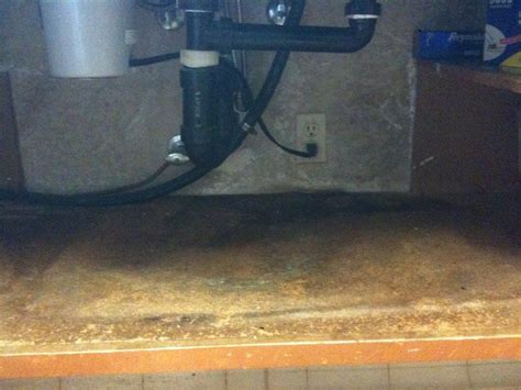 If there is not enough clearance, use a basin wrench to reach up behind the sink and remove the nuts securing the faucet handles and faucet spout tailpiece. Replacing Water Damaged Sink Cabinet | Under kitchen sinks, Sink repair, Replacing kitchen sink