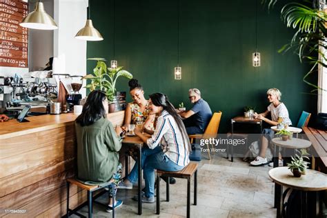 Busy Coffee Shop With Customers Sitting Down High Res Stock Photo