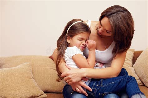 Young Mother Soothing And Hugging Crying Baby Girl Stock Photo Image