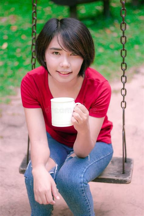 Asian Girl Drinking Coffee And Smile In The Garden Stock Image Image