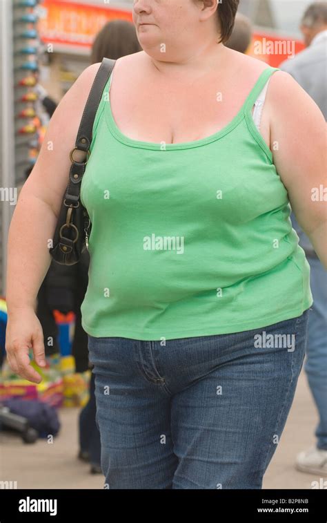 Ordinary Fat Young Woman On Holiday Wearing Green T Shirt And Blue
