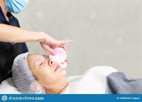 Beautician Cleanses Skin Woman With A Sponge In Spa Treatment Skin Care