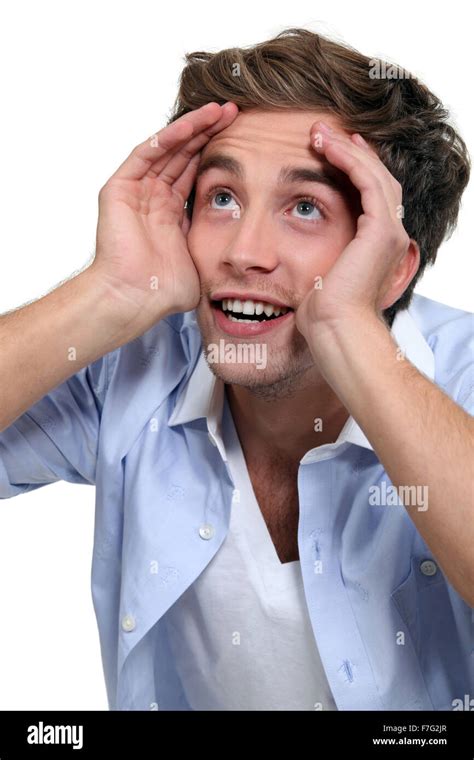Young Man Cupping His Hands Around His Eyes Stock Photo Alamy