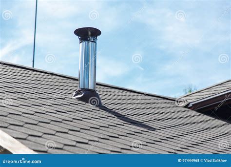 Chimney Pipe From Stainless Steel On The Roof Of The House Stock Photo