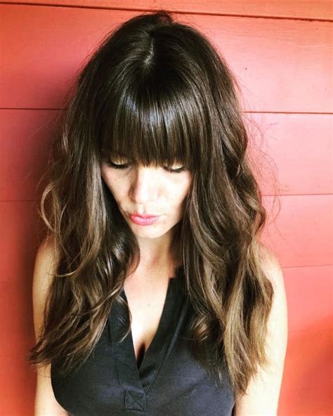 Fringe of hair covering the human forehead. messy layers with heavy bangs | Long layered hair, Layered ...