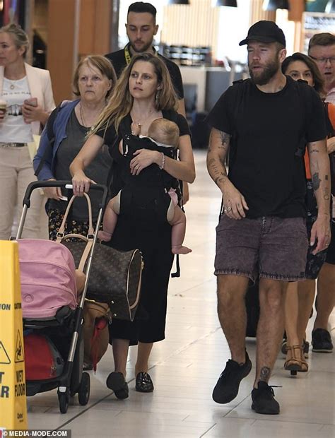 In the photo, the actress laid by a pool with the baby on her. Makeup-free Teresa Palmer juggles her three children at ...