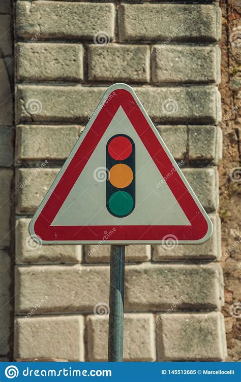 Traffic Signal Ahead Road Sign In Front Of Stone Brick Wall Stock Image