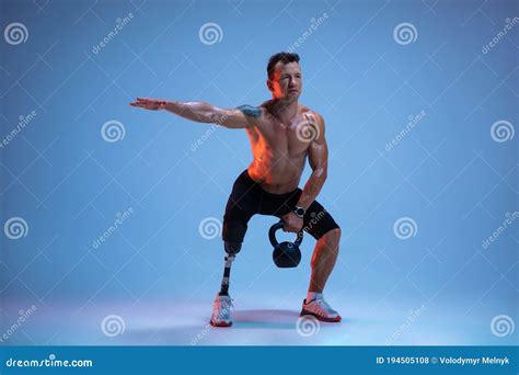 Athlete With Disabilities Or Amputee On Blue Studio Background