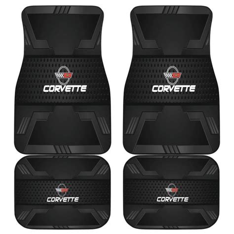 Four Black Car Mats With Corvette Logo On Them