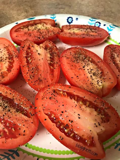 Sliced Tomatoes On A Plate With Seasoning Sprinkled On The Top And Bottom