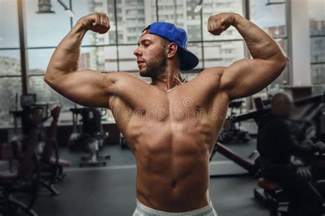 Muscular Young Man Shows His Muscles In The Gym Stock Image Image Of