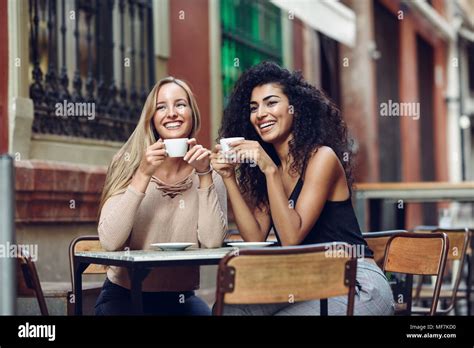 Two Happy Friends Drinking Coffee In Sidewalk Cafe Stock Photo Alamy
