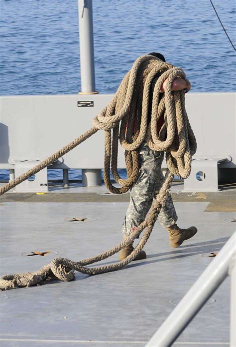 A Deck Hand Carries Line On The Deck Of The U S Army NARA DVIDS Public Domain Archive
