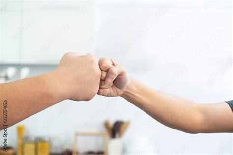 Fat Man And Trainer Bumping Fists On Kitchen Room Trainer And Fat Man Giving Fist Bumping Stock