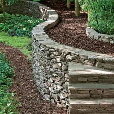 Retaining wall installation dig trench. How to Build a Retaining Walls » DenBok Landscaping & Design