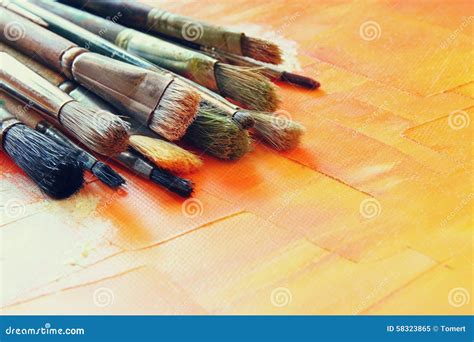 Top View Of Set Of Used Paint Brushes Over Wooden Table Stock Image