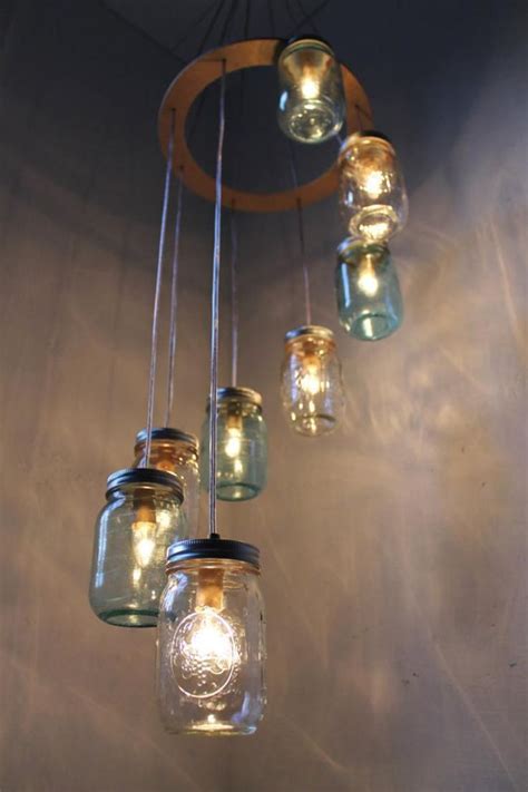 Mason Jar Chandelier With Lights Hanging From It