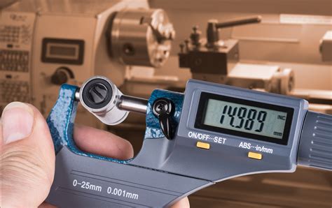 Detail Of Skilled Workers Hand With Digital Micrometer Screw Gauge And