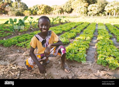 Little Black African Boy Child Smiling In Front Of Agricultural Camp In