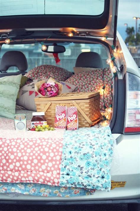 The Trunk Of A Car Filled With Pillows And Blankets