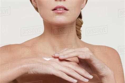 Nude Caucasian Woman Applying Moisturizer Stock Photo Dissolve