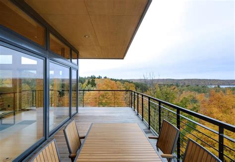 Climb the stairs to the fabulous third floor roof top deck that offers wonderful views in all directions. 4-Storey Tall House Reaches Above the Forest to See the Lake