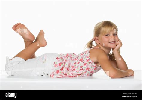 Girl 4 5 With Feet Up Lying On White Background Smiling Portrait