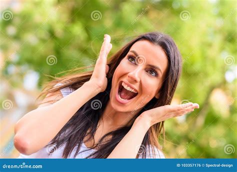 Portrait Of A Happy Young Woman Being Cheerful In A Park Stock Photo