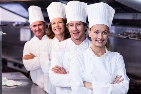 Happy Chefs Team Standing Together In Commercial Kitchen Stock Image