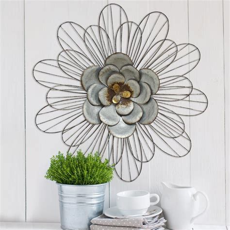 Most wall art comes with wire or slots for nails or pins for hanging. Stratton Home Decor Galvanized Metal Daisy Wall Decor-S07658 - The Home Depot
