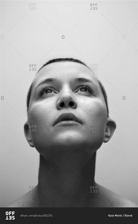 Caucasian Woman With Shaved Head Looking Up Stock Photo Offset