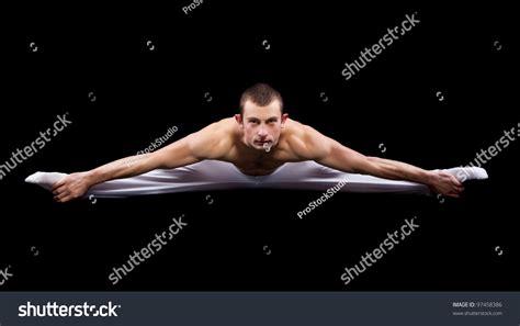 Man Acrobatics Gymnastic Doing Twine Exercise Isolated On Black