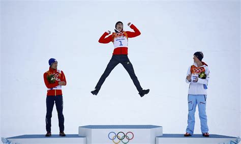 Winner Germanys Frenzel Jumps On The Podium During The Flower Ceremony