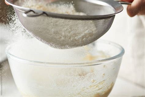 Close Up Of Sieving Flour And Bowl By Stocksy Contributor Martí