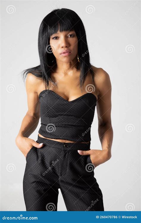 Vertical Shot Of A Brunette Female Model Posing In Elegant Black