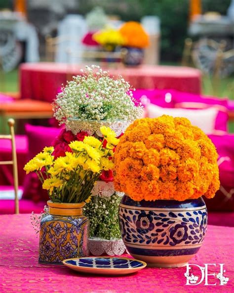 Colorful Flowers Are In Vases On A Table