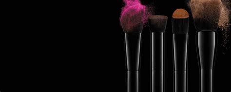 Brushes With Coloured Make Up On A Dark Background