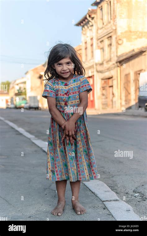 Young Gypsy Girl Barefoot On An Empty Street During Summer In Craiova