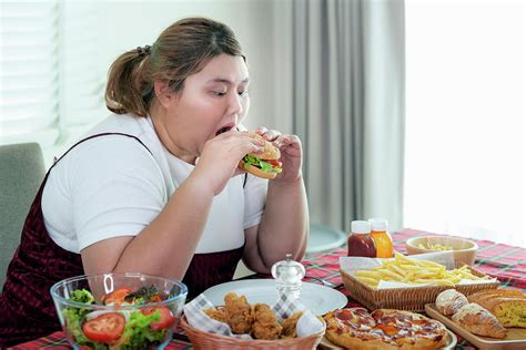 Asian Fat Girl Hungry And Eat A Junk Food On The Table Photograph By Anek Suwannaphoom Pixels