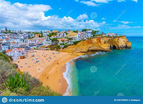 People Are Sunbathing On Praia De Carvoeiro Beach In Portugal Editorial