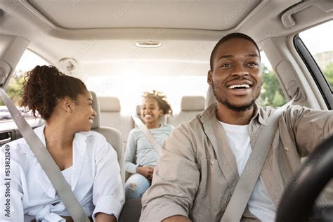 Black Parents And Daughter Sitting In Auto During Road Trip Stock Photo