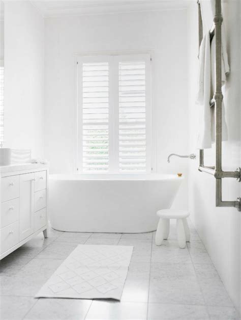 The light colors of the wood like ceramic tiles and the white bathroom fixtures look brighter as natural lighting passes through floor to ceiling glass walls. White Bathrooms Can Be Interesting Too - Fresh Design Ideas