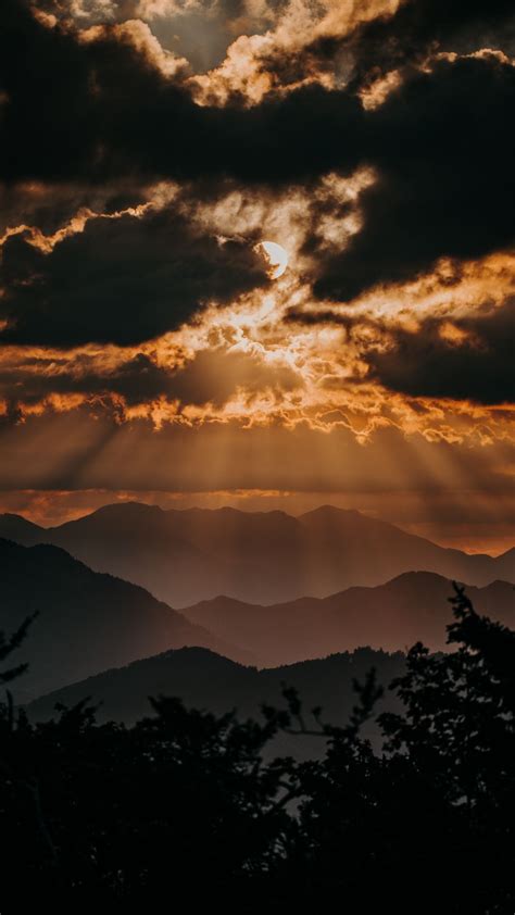 1080x1920 Mountains Sunbeams Clouds Sunset Horizon Wallpaper
