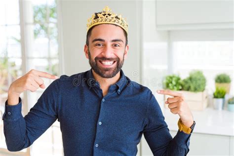 Handsome Hispanic Man Wearing Golden Crown Over Head As The King