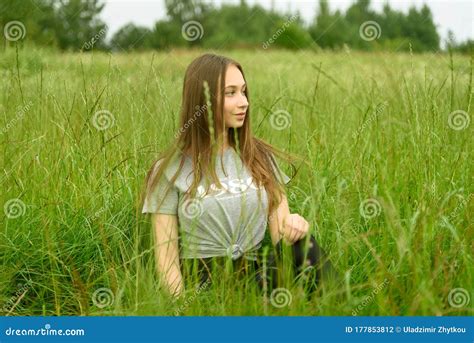 Girl Sitting In The Grass In The Meadow Stock Photo Image Of