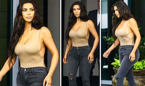Kim Kardashian Displays Major Cleavage As She Goes Braless In Skintight Nude Bodysuit