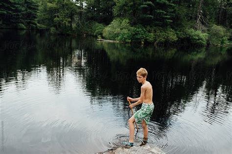 Boy Playing In A Lake By Stocksy Contributor Léa Jones Stocksy