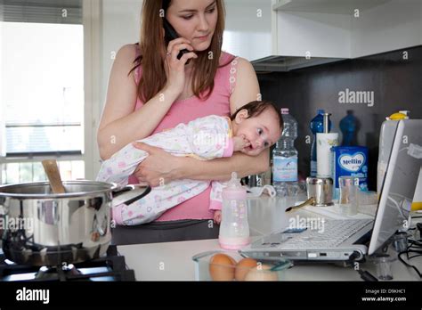 Mom Multitasking Kitchen Hi Res Stock Photography And Images Alamy