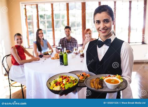 Waitress Holding Food On Plate In Restaurant Stock Photo Image Of