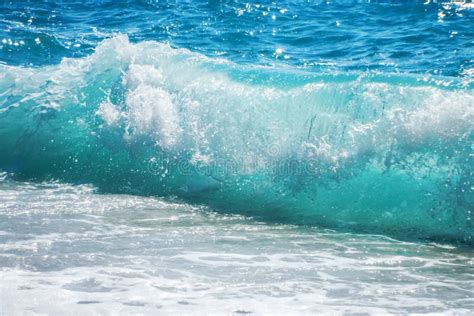 Breaking Wave Of Blue Ocean On Sandy Beach Summer Background Stock